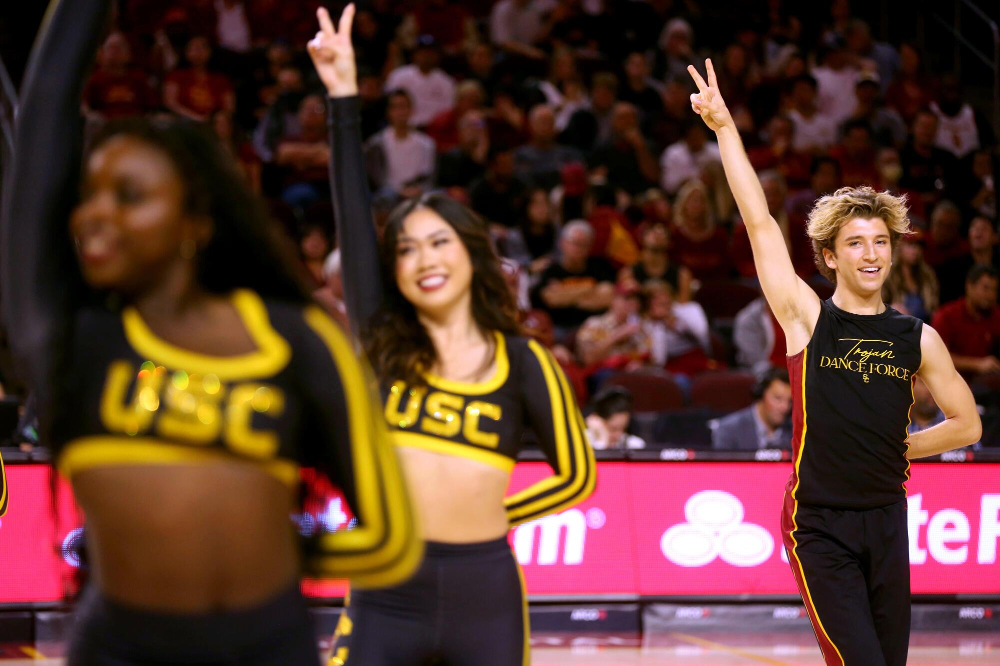 Hugo Miller, right, performs with the Trojan Dance Force during a game against UCLA at Galen Center in January.
