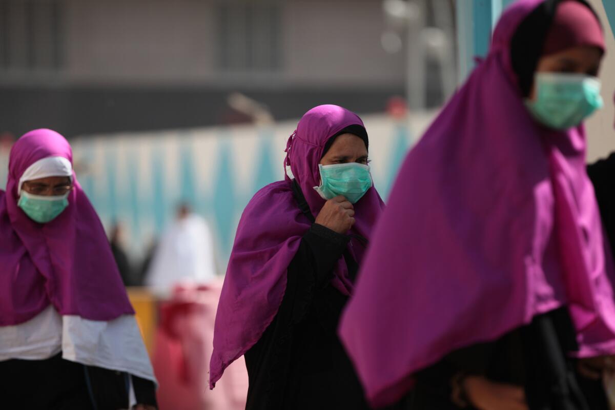 Muslim pilgrims wear surgical masks to help prevent infection from the Middle East Respiratory Syndrome, or MERS, in Mecca, Saudi Arabia, on Tuesday.