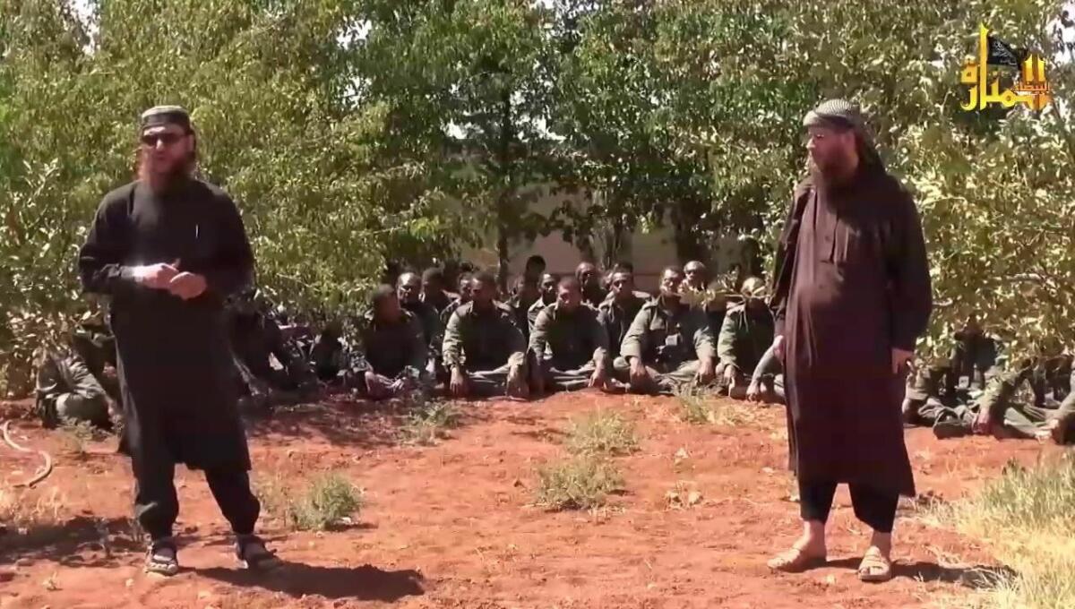 An image taken from a YouTube video released on Sept. 10 shows two Nusra Front leaders standing in front of captured U.N. peacekeepers.