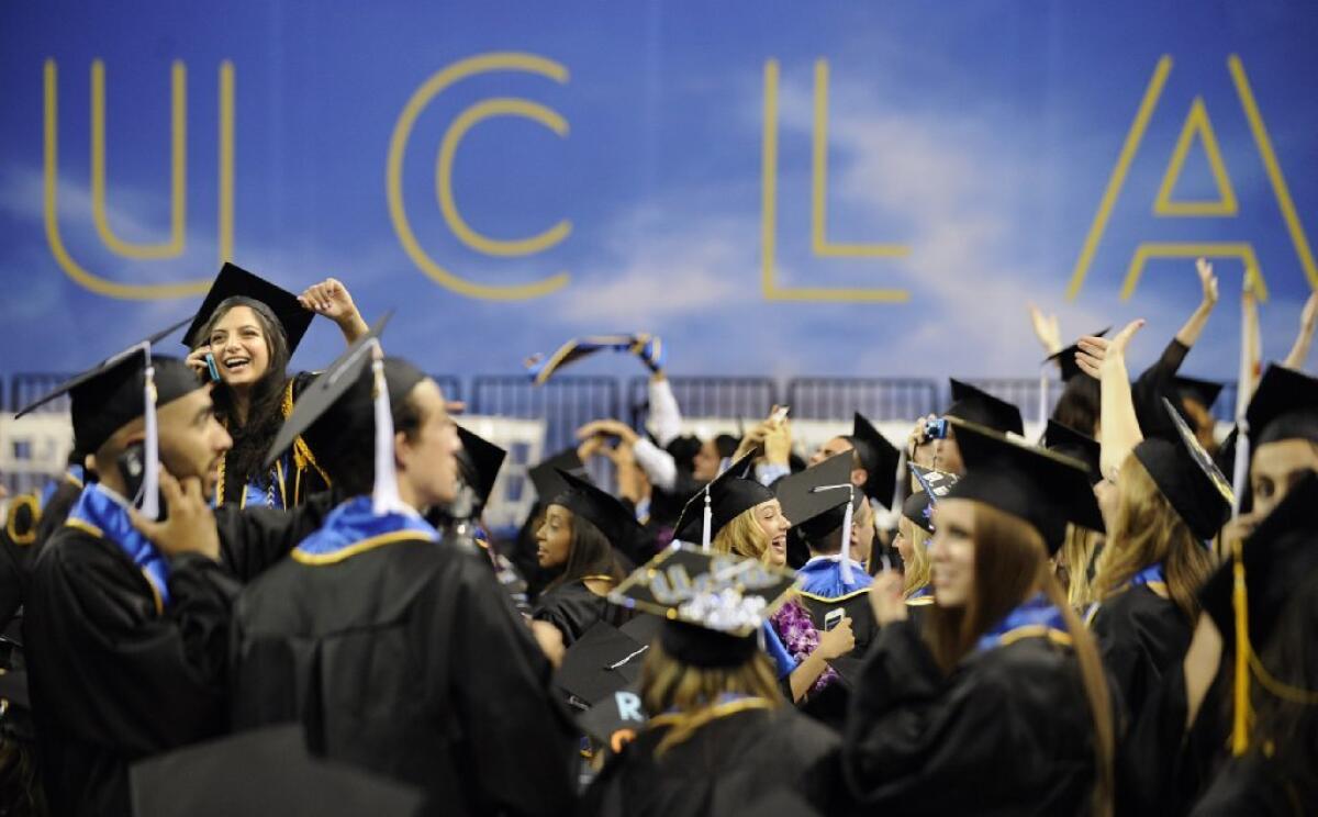 Graduates of UCLA wave to friends and family before the start of commencement ceremonies in June 2013.