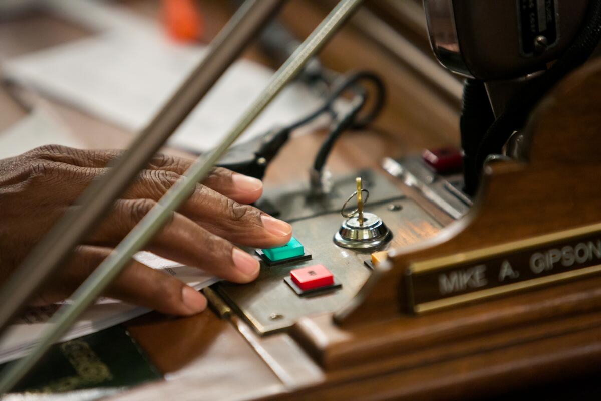 Assemblyman Mike Gipson votes by pressing a yes or no button on his desk on the assembly floor in Sacramento in 2015. New organizational rules offer a narrow interpretation of a new waiting period for voting on bills.