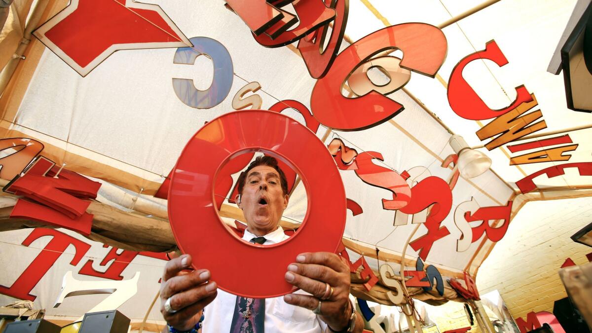 Nick Metropolis, shown in 2014 inside a tent of alphabet letters for sale at his store, survived eviction hearing. He is on a payment plan.