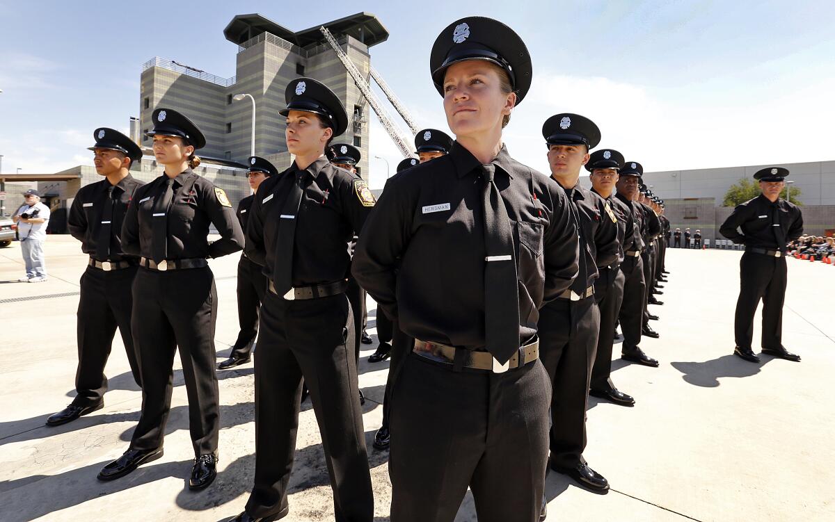 Katie Becker, center, at her April 2016 graduation ceremony from the Los Angeles Fire Department's Academy. 