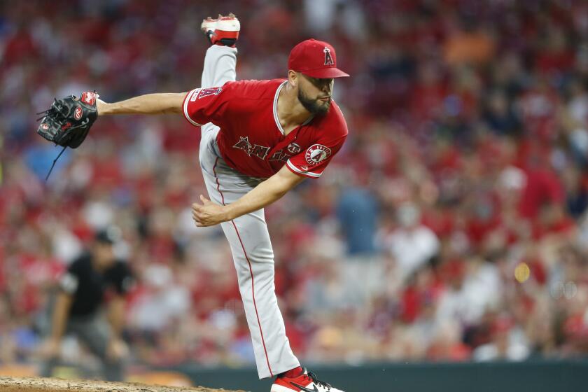 Los Angeles Angels pitcher Patrick Sandoval follows through on a through in his major league debut during the fifth inning of a baseball game against the Cincinnati Reds, Monday, Aug. 5, 2019, in Cincinnati. (AP Photo/Gary Landers)