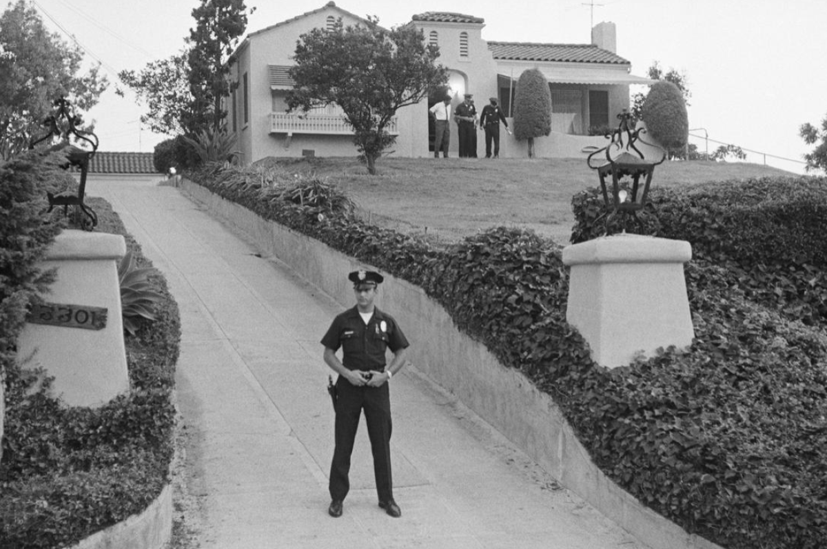 A Los Angeles police officer outside the Los Feliz house in 1969 after Manson murders.