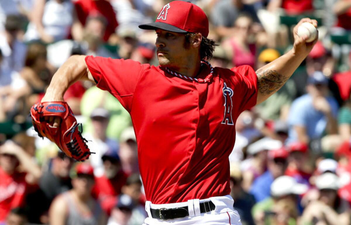 Angels starting pitcher C.J. Wilson delivers a pitch in the first inning against the Padres on Sunday.