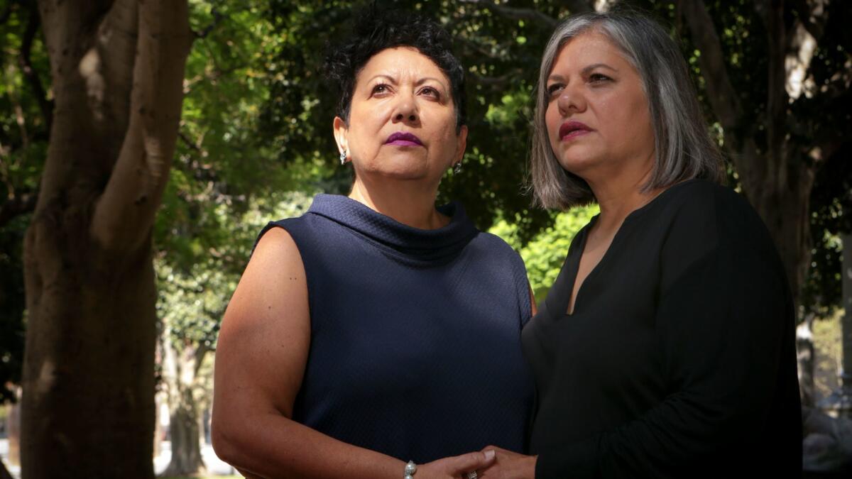 Judith Dominguez, left, and wife Patricia Martinez of Alhambra say Colorado-based Cherry Creek Mortgage refused to provide them spousal health insurance coverage because of their sexual orientation.