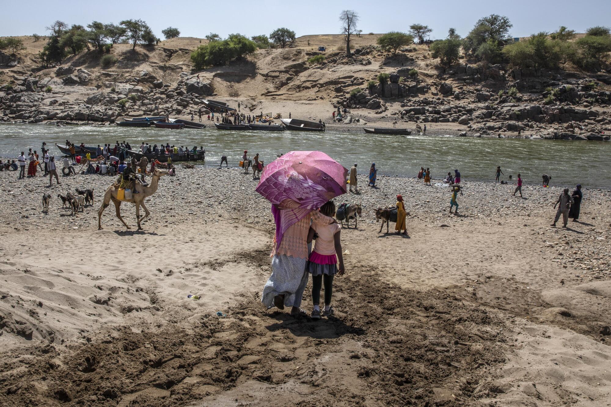 Refugees from Tigray arrive on the banks of the Tekeze River on the Sudan-Ethiopia border