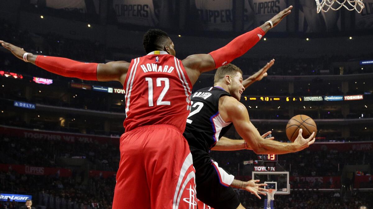 Clippers forward Blake Griffin has his layup challenged by Rockets center Dwight Howard during their game Saturday.