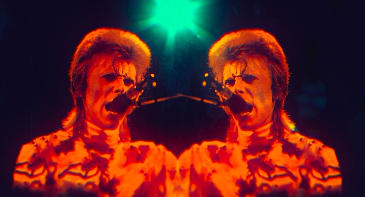 Two matching juxtaposed photographs of David Bowie as "Ziggy Stardust."