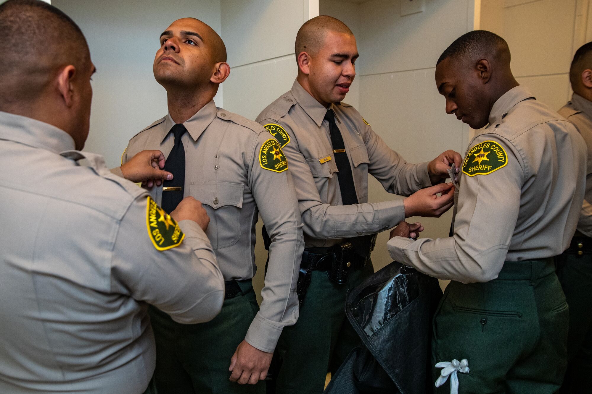 Los Angeles County Sheriff Academy Class 464 graduates Jorge Valenzuela Jr., left, Xavier Sandoval, Oscar Mora 