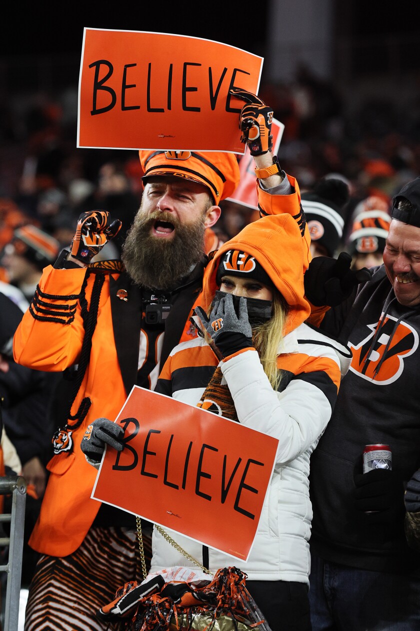 Bengals fans hold up signs during Cincinnati's 26-19 victory against the  Las Vegas Raiders in an AFC Wild Card game.