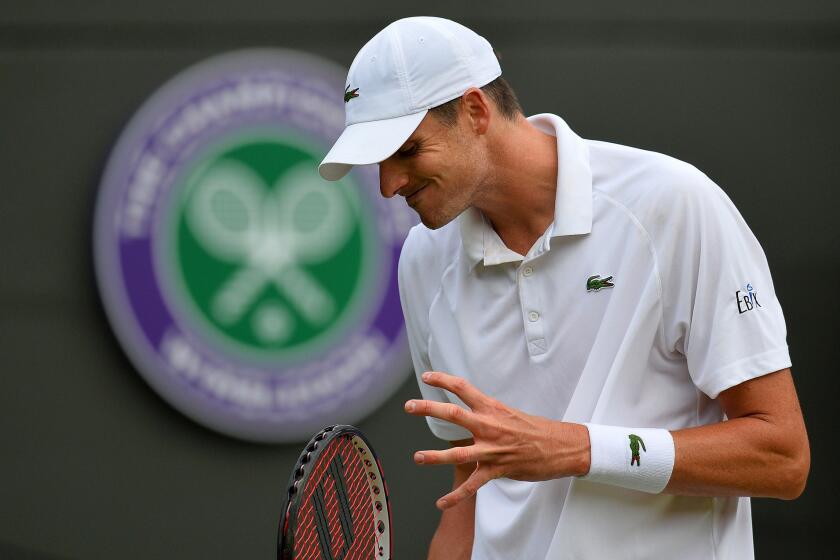 John Isner reacts after losing a point to Marin Cilic during their third-round match at Wimbledon on Friday.