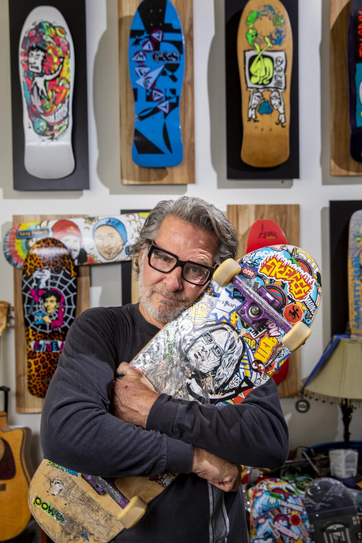 Jim Gray poses with a skateboard in his Costa Mesa office.