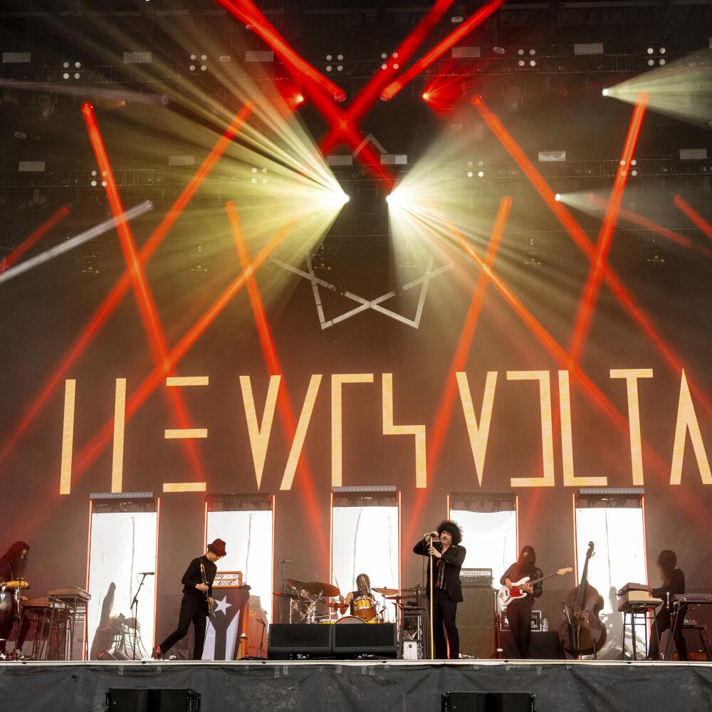 The Mars Volta performs onstage under red laser beams
