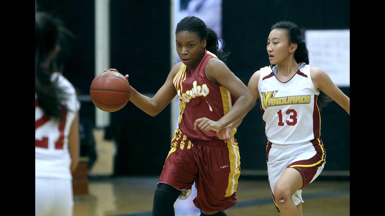 Ocean View High School girls basketball player #1 Hosanna Walker moves the ball up court in game vs. El Modena High School during play in the Villa Park High School Tournament in Villa Park on Tuesday, Dec. 19, 2017.