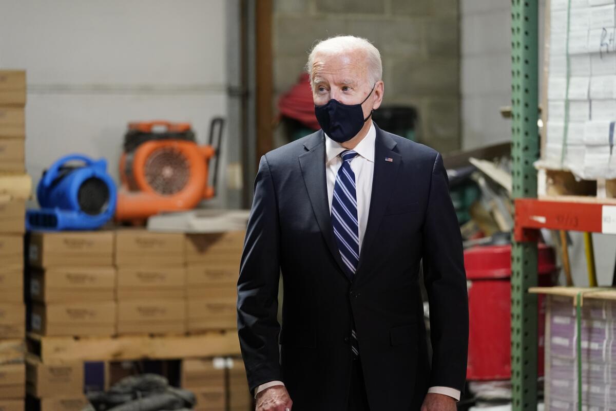 President Biden wears a mask as he visits a factory in Pennsylvania.