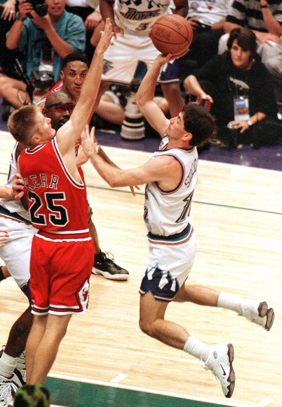 The Bulls' Steve Kerr defends the Jazz's John Stockton as he launches the game-winning shot in overtime of Game 1 in the 1998 NBA Finals.