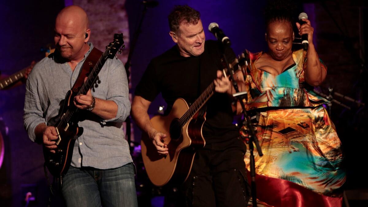 Johnny Clegg, center, photographed in New York in 2014, was first arrested at age 15 for collaborating with black musicians in South Africa in defiance of the country's apartheid laws.