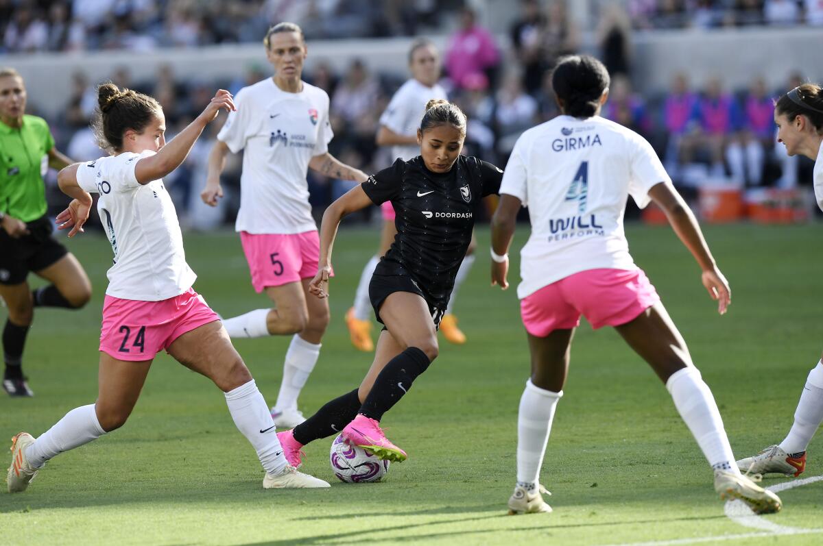 Angel City FC's Alyssa Thompson controls the ball against San Diego Wave FC's Danielle Colaprico.