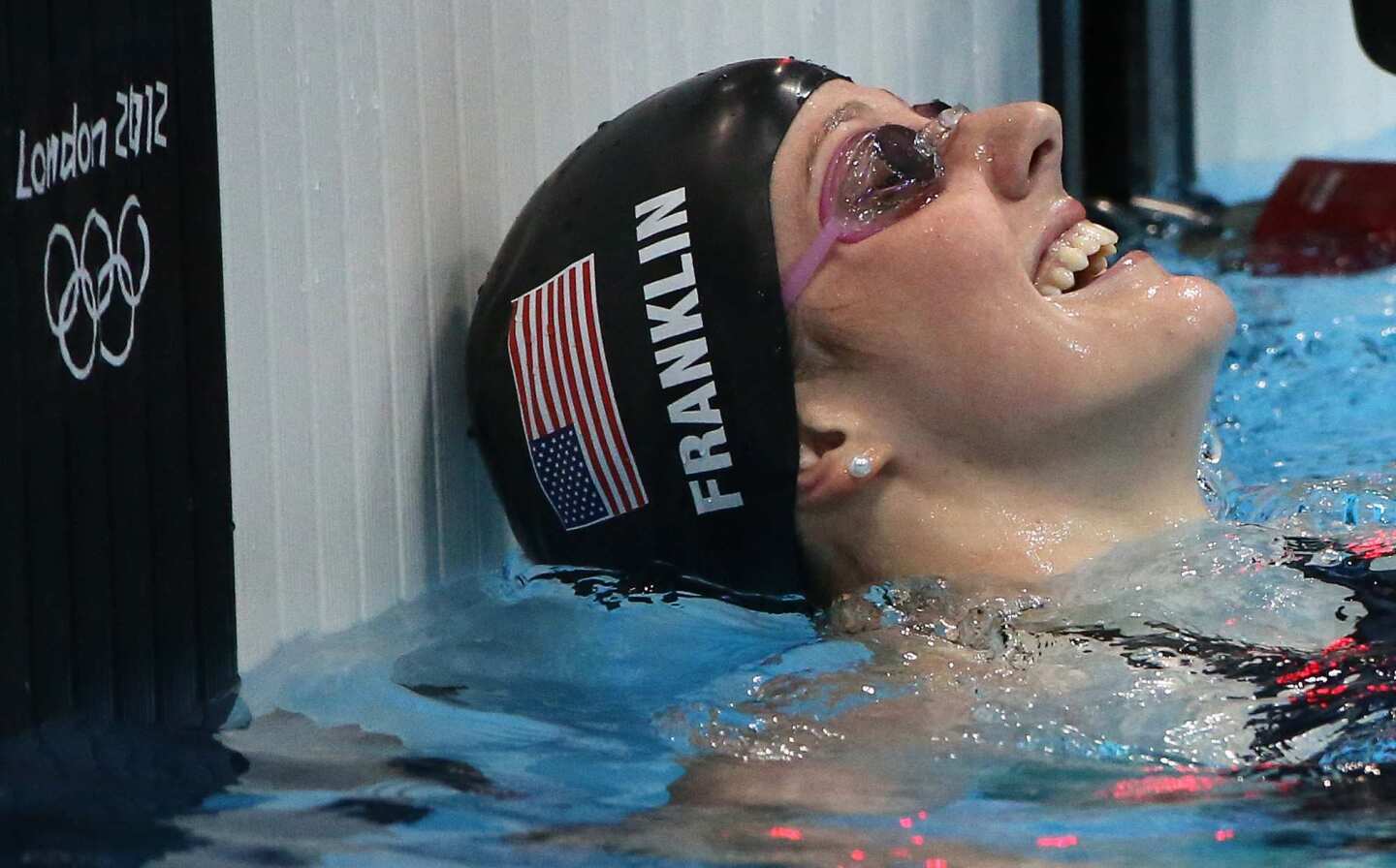 U.S. swimmer Missy Franklin smiles with a mixture of relief and joy after winning the women's 100-meter backstroke final at the London 2012 Olympics.