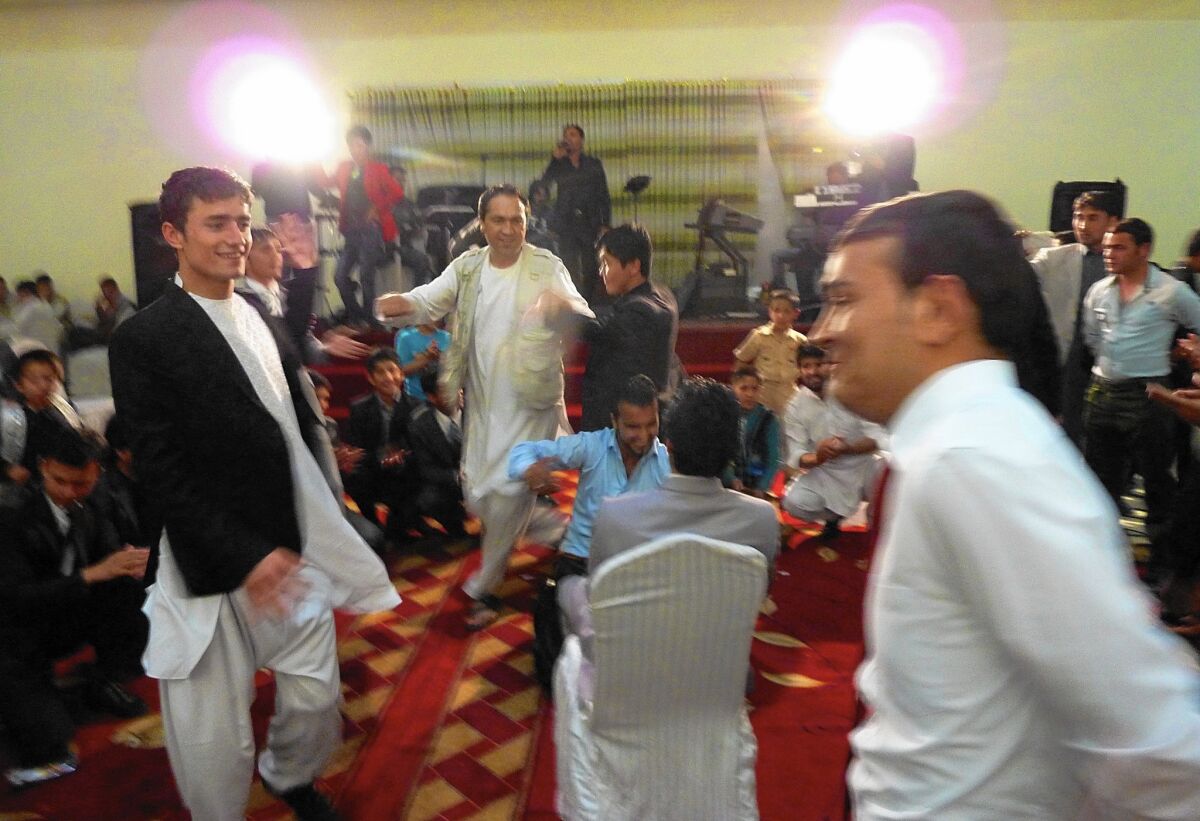 Afghan weddings, such as this one in Kabul, often take place in lavish halls. A law passed in March aims to rein in what is traditionally a very costly celebration.