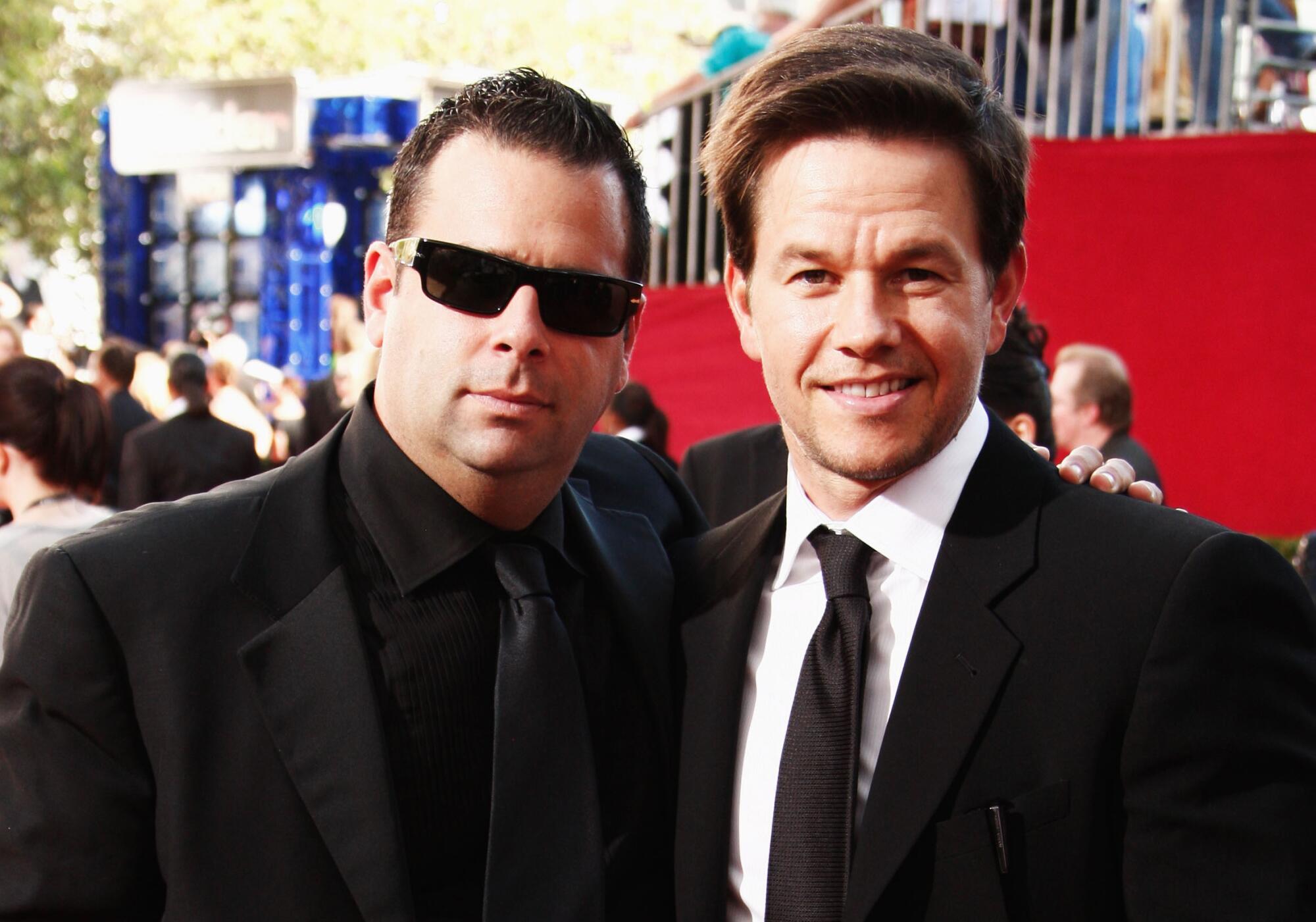 Actor Mark Wahlberg, right, and Randall Emmett arrive at the 61st Primetime Emmy Awards.