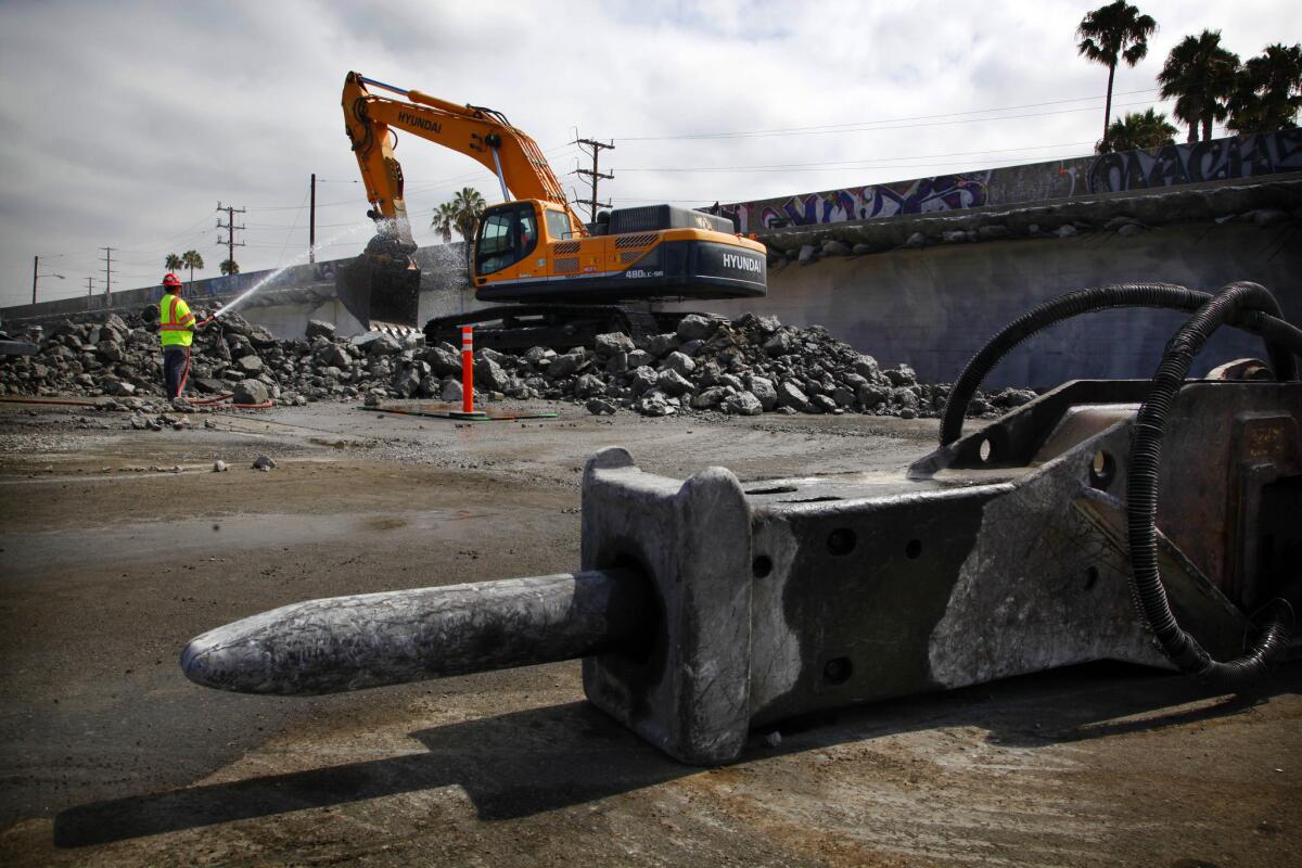 Workers prepare to demolish a bridge near LAX. The demolition is set to be completed this weekend, requiring the closure of the intersection of Century and Aviation boulevards for 57 hours starting Friday evening.
