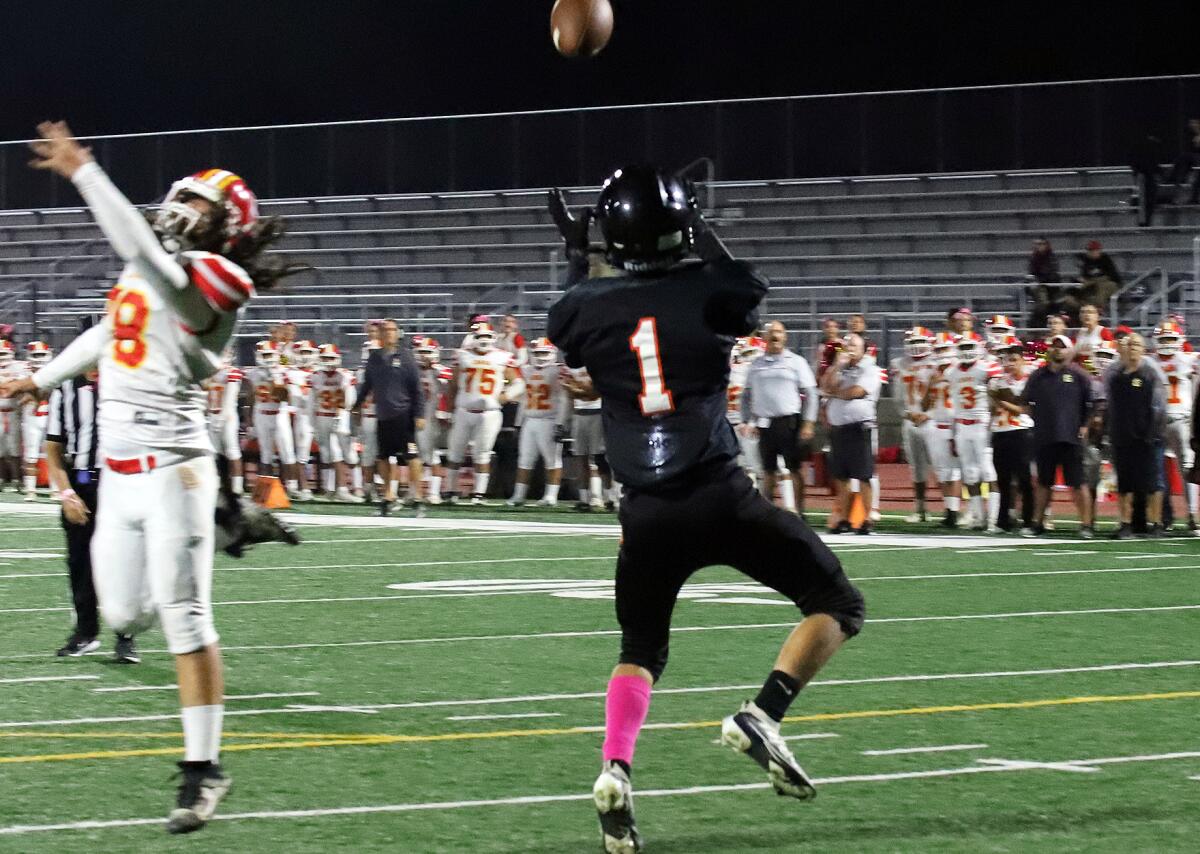 Los Amigos' Adrian Ramirez (1) catches a pass for a touchdown in the second quarter against Loara on Thursday.