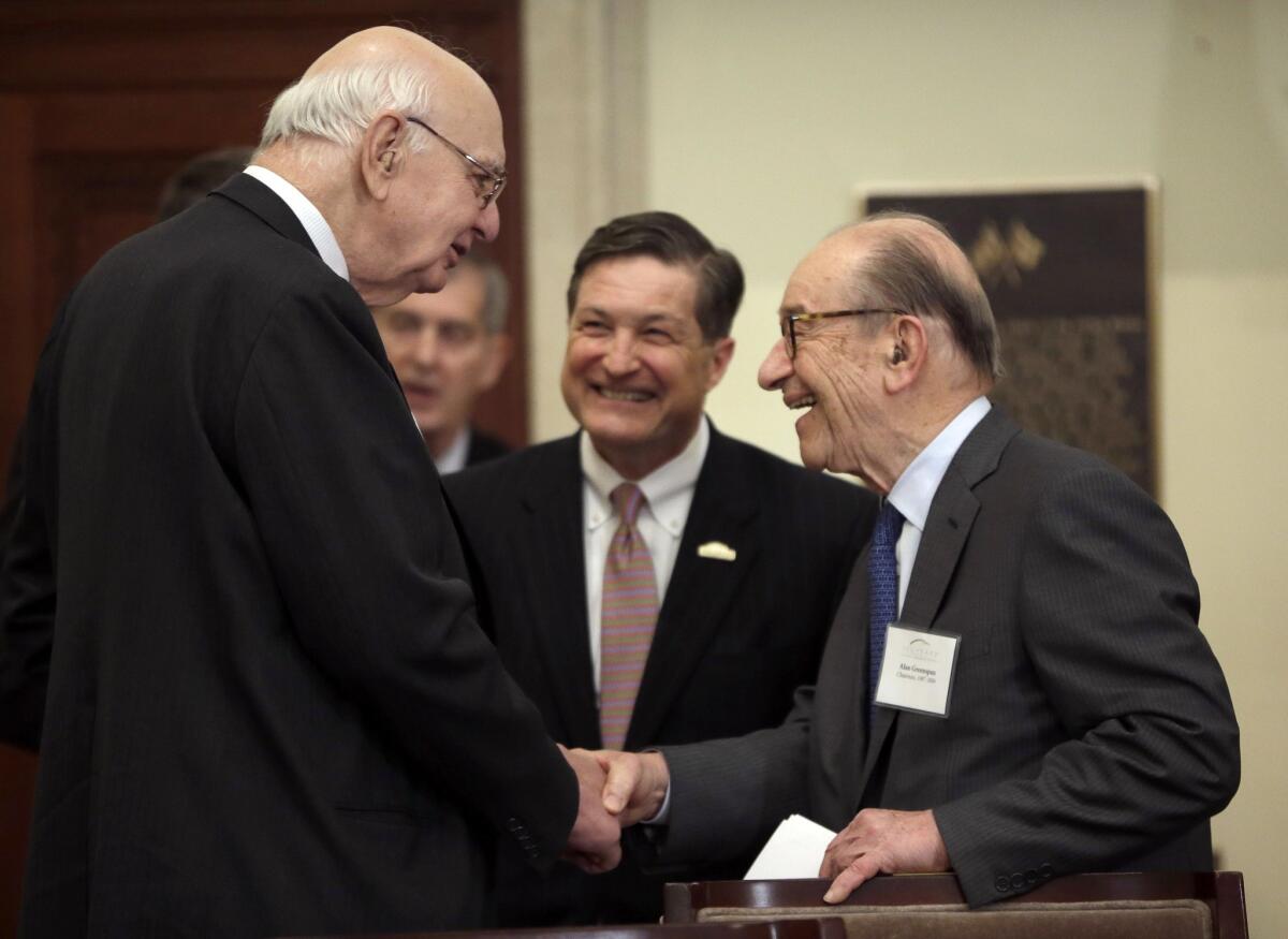 Jeffrey M. Lacker, center, president of the Federal Reserve Bank of Richmond, Va., watches as former Fed chairmen Paul Volcker, left, and Alan Greenspan, right, shake hands before a ceremony commemorating the 100th anniversary of the central bank.