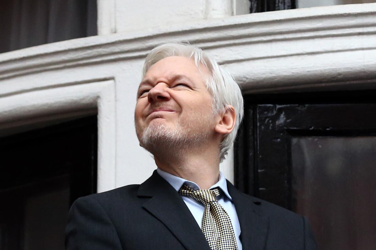 Wikileaks founder Julian Assange squints in the sunlight as he prepares to speak from the balcony of the Ecuador Embassy in London in February.
