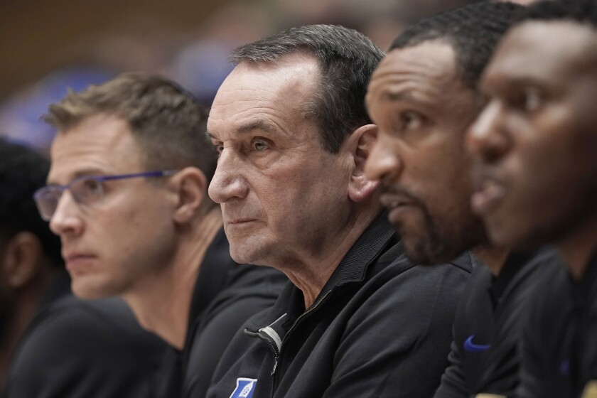 Duke coaches, from left, Jon Scheyer, head coach Mike Krzyzewski, Chris Carrawell and Nolan Smith watch from the bench during the first half of an NCAA college basketball game against Campbell in Durham, N.C., Saturday, Nov. 13, 2021. (AP Photo/Gerry Broome)