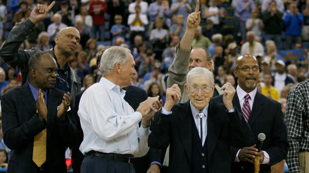 In 2007, UCLA players Lucius Allen, Kareem Abdul-Jabbar, Ken Heitz and Mike Warren celebrate the 40th anniversary of their NCAA championship with assistant coach Jerry Norman and coach John Wooden.