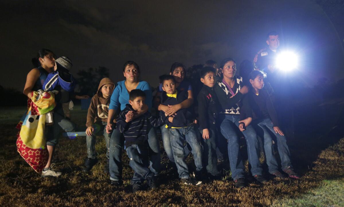 A group of immigrants from Honduras and El Salvador who crossed the U.S.-Mexico border illegally are stopped in Granjeno, Texas, in June.