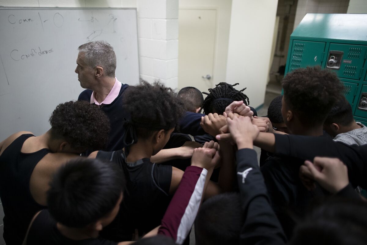 Roybal High School basketball coach Danny O'Fallon sends his team to the court before a state tournament game against Providence.