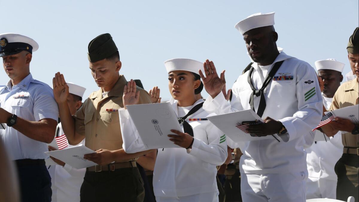 Ayesha Willy (second from right) from Philippines enlisted in the U.S. Navy in 2017 and on Tuesday took the oath to finalize her U.S. citizenship on board the USS Midway Museum.