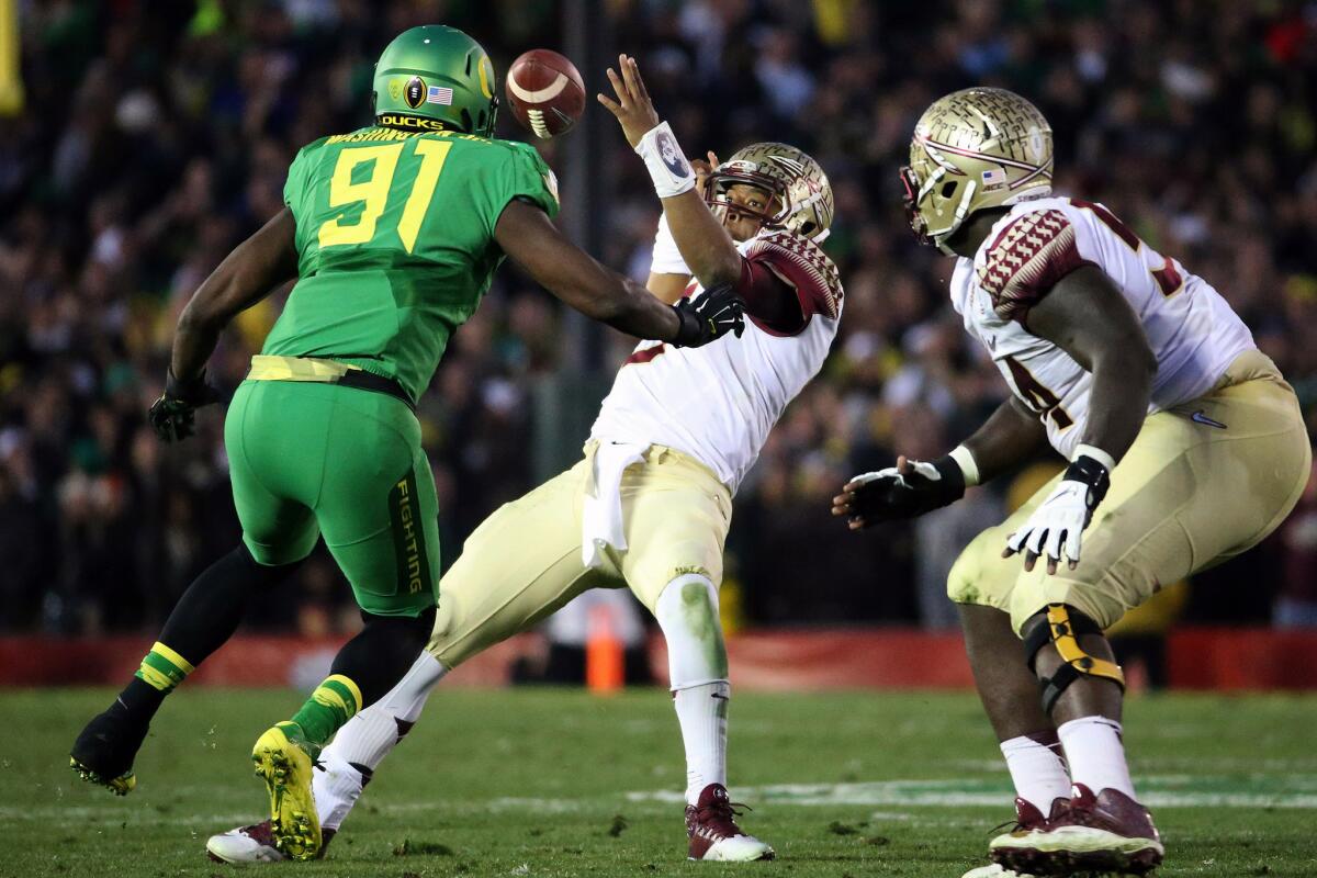 Seminoles quarterback Jameis Winston fumbles the ball as he tries to change direction as he's pressured by Ducks linebacker Tony Washington in the third quarter.