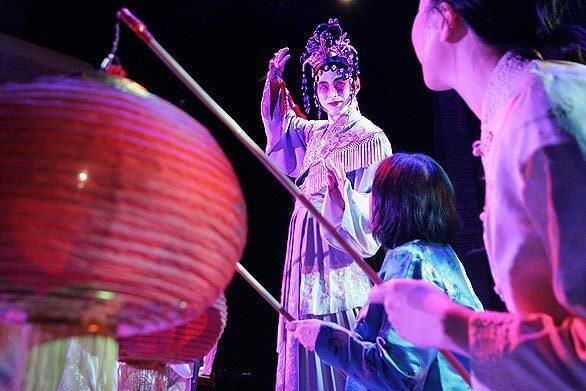 Edward Gunawan plays the Moon Lady in an ensemble scene from the East West Players production of "The Joy Luck Club," based on the bestselling book by Amy Tan. The Los Angeles premiere of the play runs to Dec. 7.