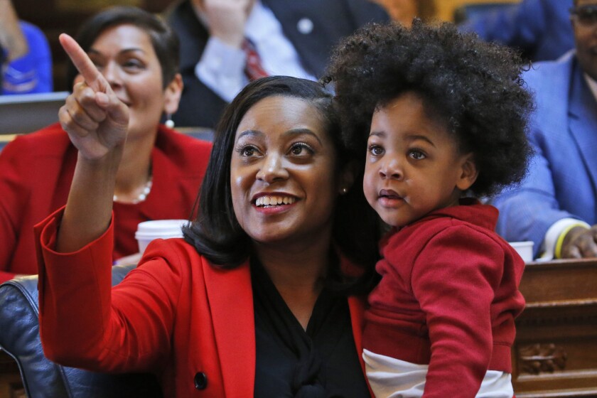 Jennifer Carroll Foy points while holding one of her twin sons, Alex