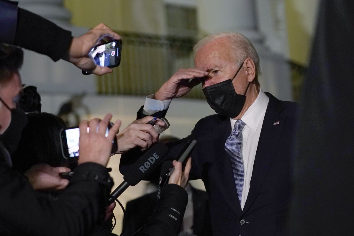 President Joe Biden talks with reporters at the White House in Washington, Friday, Dec. 3, 2021, as he prepares to leave for Camp David. (AP Photo/Susan Walsh)