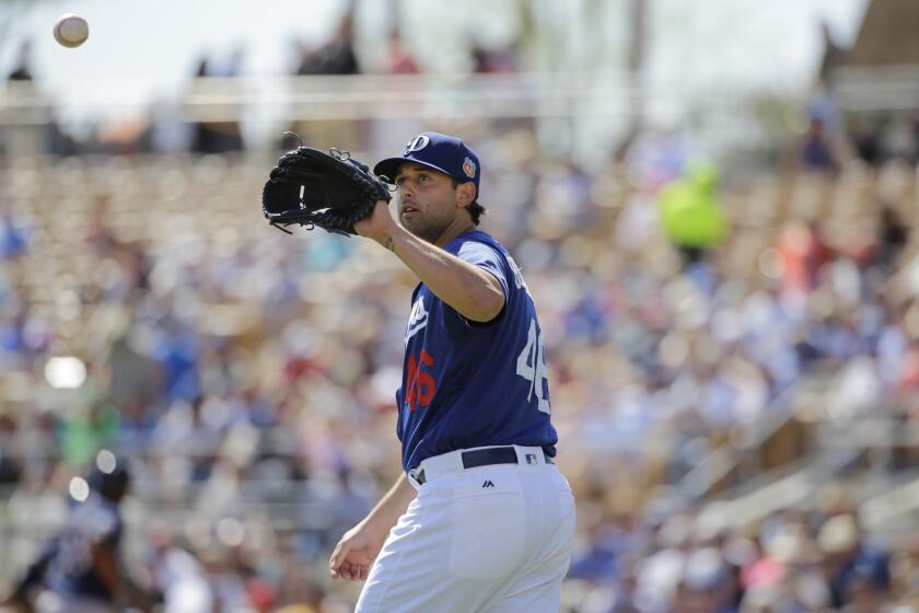 Dodgers right-hander Mike Bolsinger catches a ball during the second inning of a spring training game on March 14.