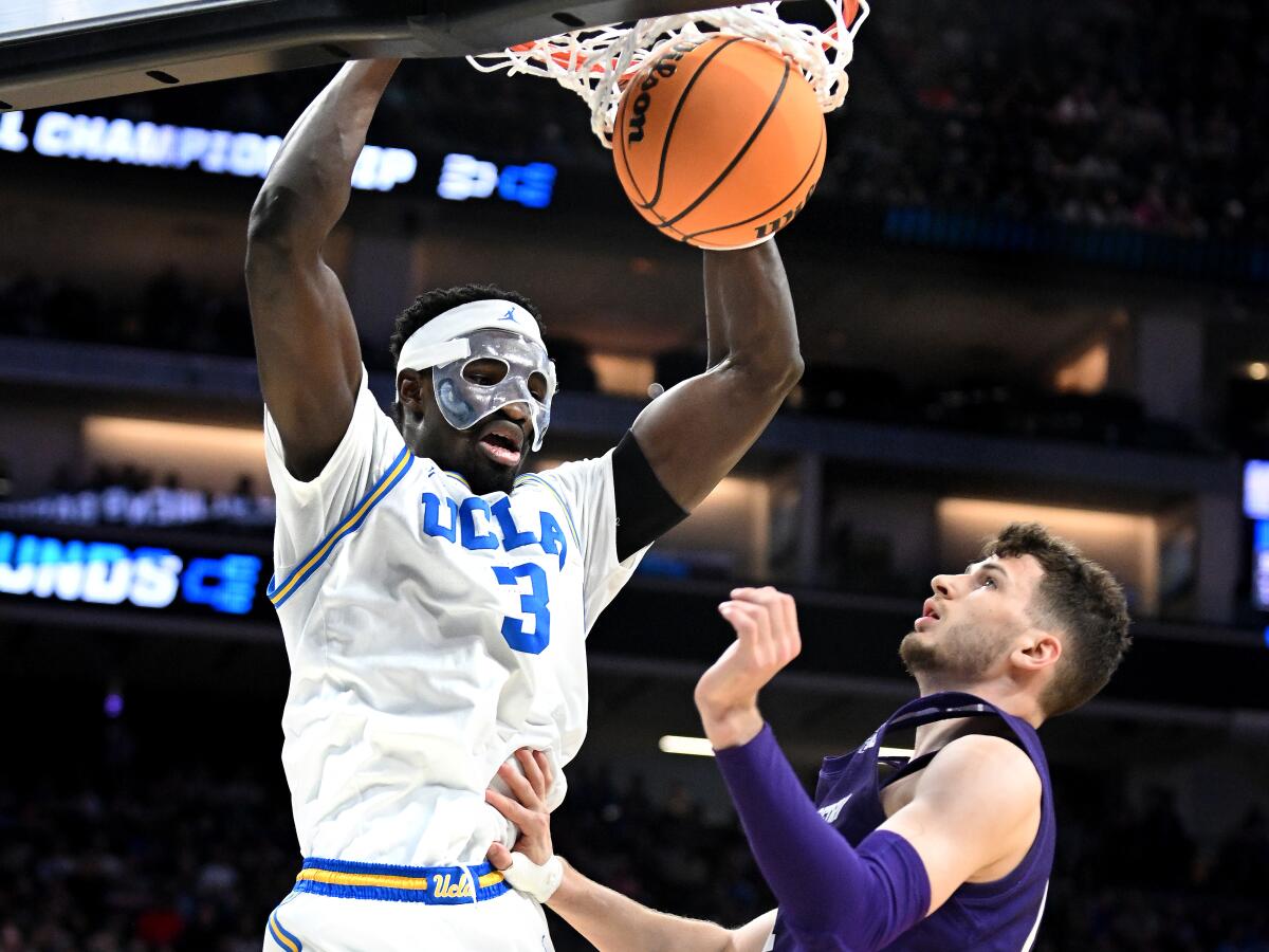 UCLA's Adem Bona dunks over Northwestern's Brooks Barnhizer.