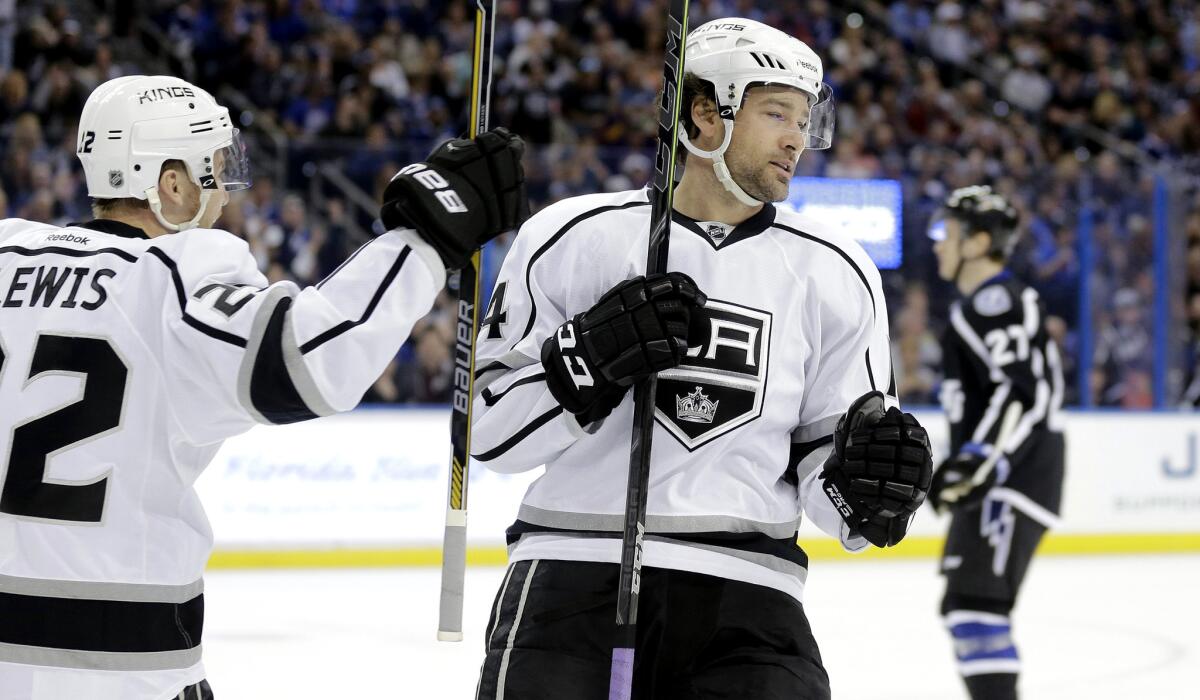 Kings right wing Justin Williams celebrates with teammate Trevor Lewis, left, after scoring in the first period, the first of his two goals in the game Saturday at Tampa Bay.