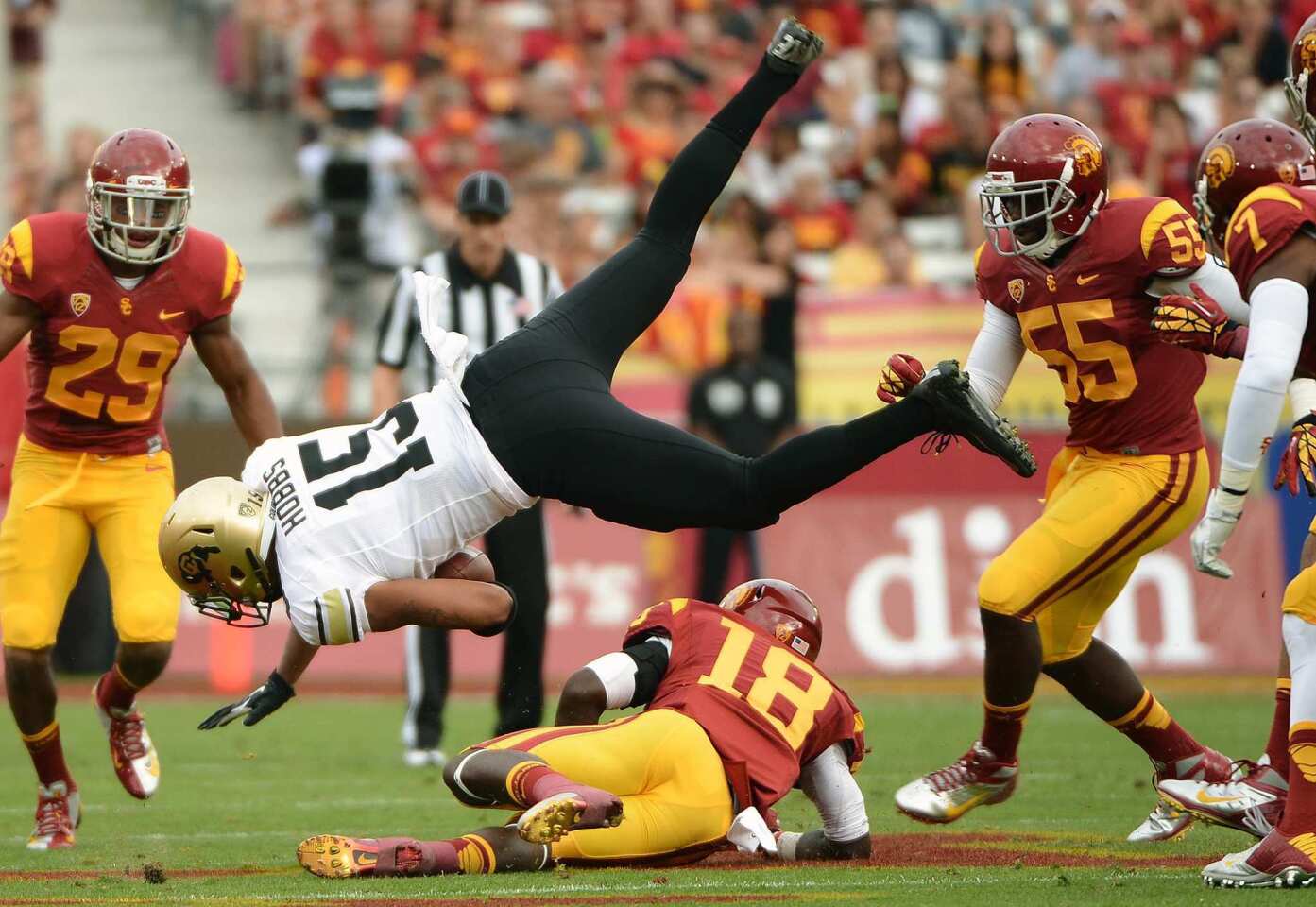 Colorado tight end Vincent Hobbs is upended by USC linebacker Dion Bailey after a reception in the first quarter Saturday.
