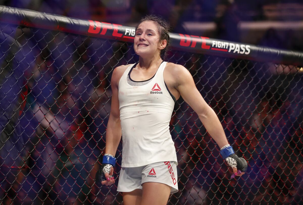 Alexa Grasso reacts after defeating Karolina Kowalkiewicz during their women's strawweight mixed martial arts bout at UFC 238, Saturday, June 8, 2019, in Chicago. (AP Photo/Kamil Krzaczynski)