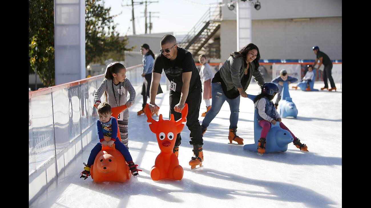 Arnulfo Reyes, Jr., of Delano, CA., and his children Katie, 8, and Arnulfo III enjoy a nice day of ice skating at the Rink in Downtown Burbank, on Friday, Dec. 15, 2017. Reyes and his family came down to Burbank for shopping and ice skating.