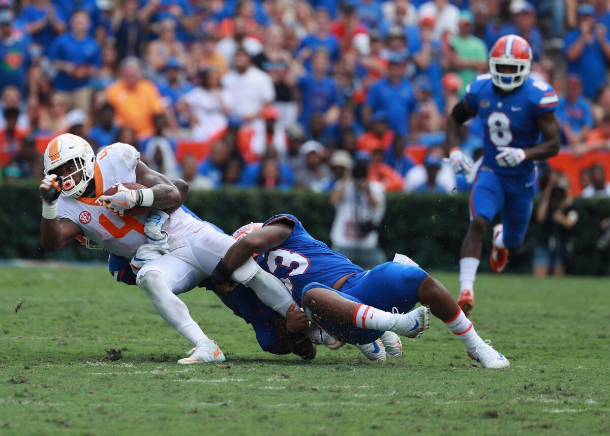 Tennessee's John Kelly is brought down by Florida's David Reese during a game last season.