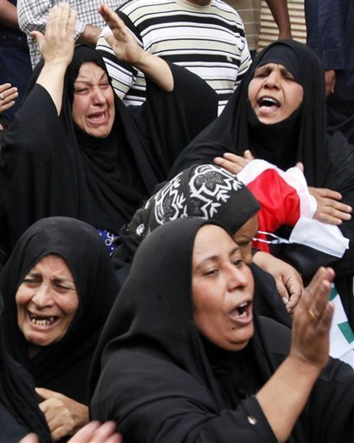 Family members mourn during a funeral for Hashem Mohammed in central Baghdad, Iraq, Wednesday, April 7, 2010. Hundreds of people are gathering for funerals after bombs ripped through apartment buildings and a market in Baghdad on Tuesday. (AP Photo/Hadi Mizban)