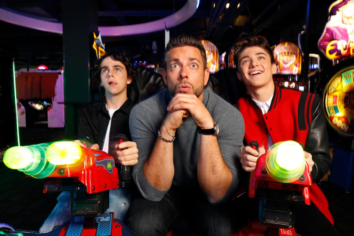 "Shazam" costars, from left, Jack Dylan Grazer, Zachary Levi and Asher Angel in the arcade at Dave & Busters in Hollywood.
