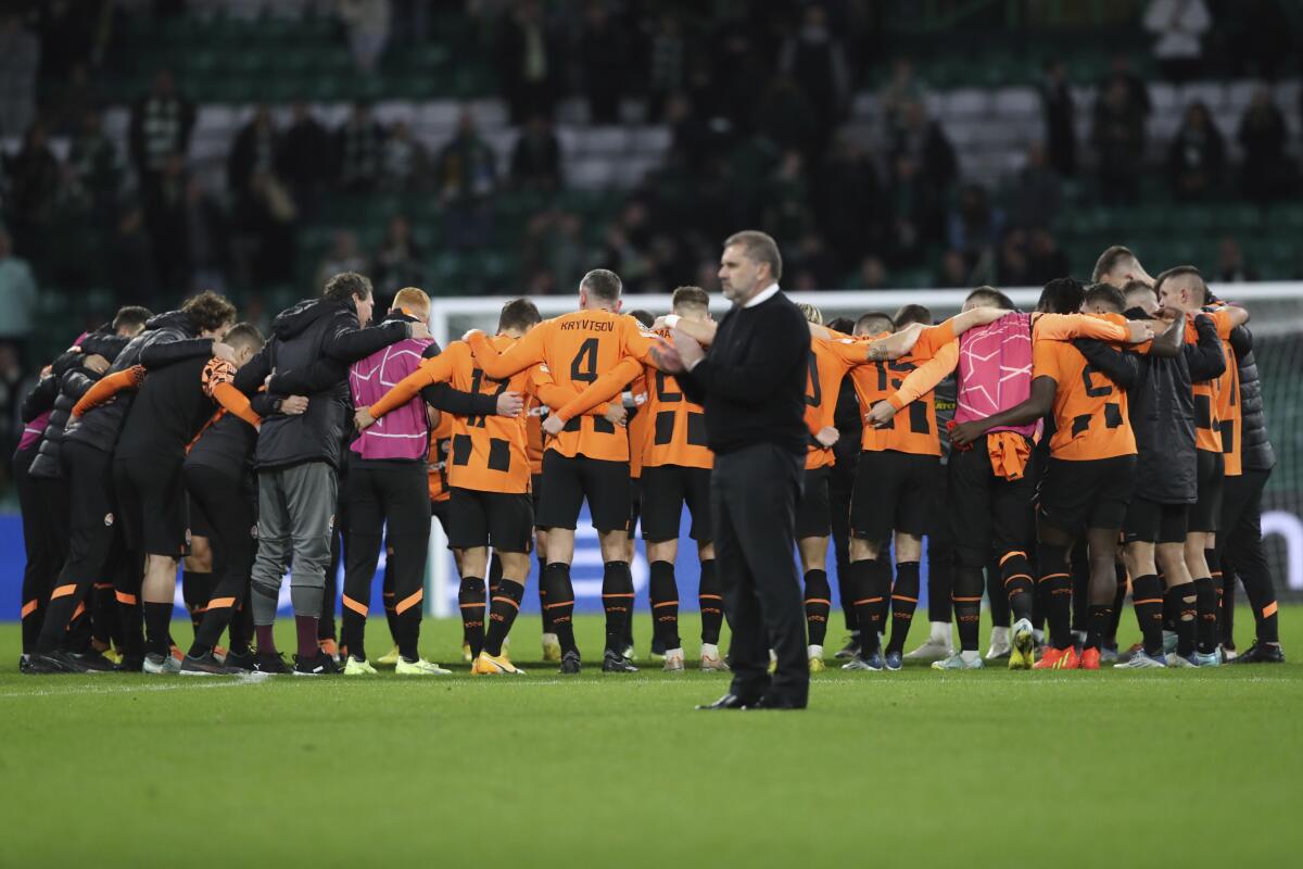Shakhtar's team players gather to hug after the Champions League Group F soccer match between Celtic and Shakhtar Donetsk at Celtic park, Glasgow, Scotland, Tuesday, Oct. 25, 2022. (AP Photo/Scott Heppell)